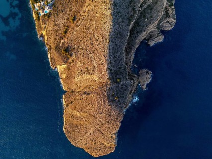 A stunning aerial view of the Costa Blanca coastline, where rugged cliffs meet the calm