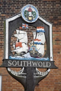 Village sign showing ships engaged in the Battle of Sole bay, Southwold, Suffolk, England, United