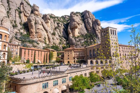 Tourists visiting the historic montserrat monastery, a benedictine abbey perched on the cliffs of