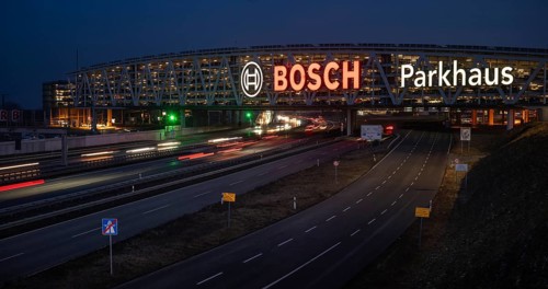 Traffic on the A8 motorway, blue hour, illuminated parking garage, Landesmesse Stuttgart, red-lit