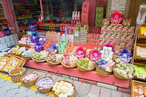 A sales stand with colorful, handmade soap products in baskets, market, Karahayit, Karahiyit,