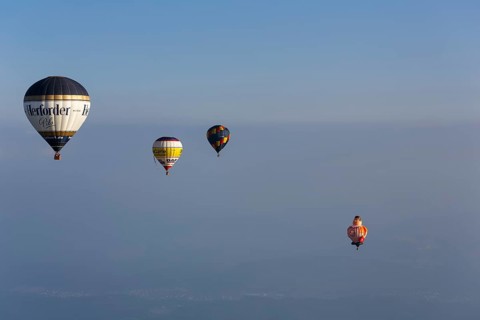 Four different hot-air balloons in the evening haze, advertising, logo, hot-air balloon festival,