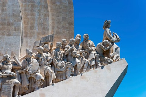 Detailed sculptural group on a monument under a blue sky, Padrão dos Descobrimentos, Monument to