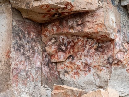 Colored hands at the wall of the canyon, Cueva de las Manos, prehistoric paintings, canyon of the