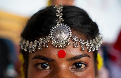 A girl from tea tribe community wearing traditional jewellery, wait to perform traditional Jhumur