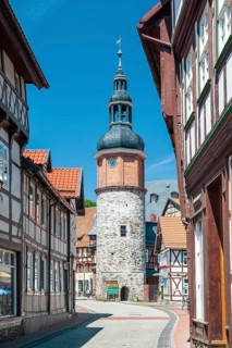 Alley with half-timbered houses and cobblestones in the historic old town, Saigerturm tower in the