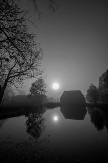 Morning sun over the estate pond on a foggy morning at Gut Othenstorf, Othenstorf near Rehna,