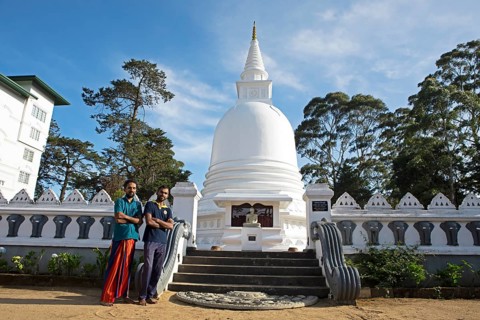 Sri Lankan men at the Chayathi Stupa in the International Buddhist Centre Temple, Nuwara Eliya,