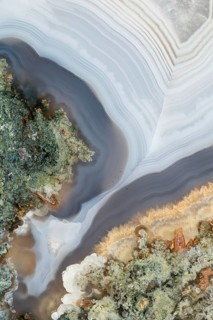 Detailed macro image of a cut and polished agate nodule, highlighting its stunning colors,
