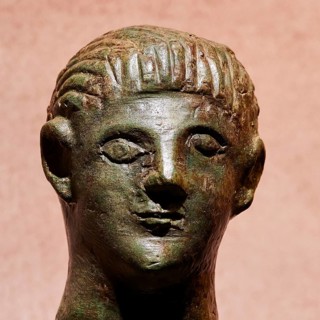 Diocouroi or athlete, ancient bronze sculpture of a head with neutral expression and fine details,