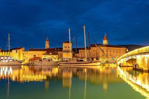 Cruise ships in front of the old town centre of Trogir at dusk, Croatia