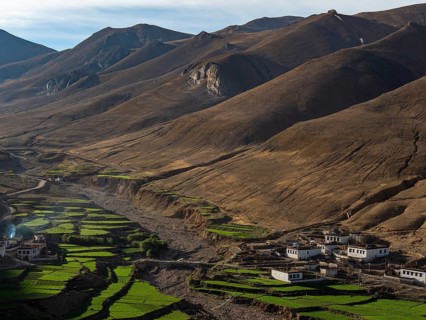 Village between green terraces, rice cultivation and agriculture in the highlands of Tibet, China