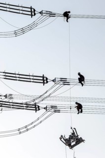 Overhead line fitters working on a high-voltage pylon, overhead lines, energy, worker, high-voltage