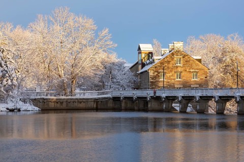 Moulin Neuf water flow control dam and walkway over Des Mille-Iles river plus New Mill on Ile des