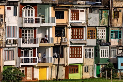Urban residential complex with various façade colors and balconies, A house facade in Ratnapura in