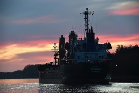 Cargo ship ADAVEGA sailing at sunrise in the Kiel Canal, NOK, Kiel Canal, Schleswig-Holstein,