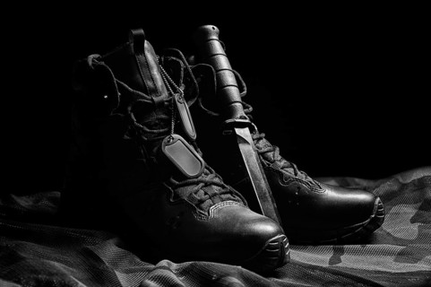 Military boots. The concept of war, veterans, fallen fighters. Sale of military shoes.