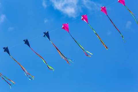 Strung kites flying in the blue sky, garland, kite festival in Vinsebeck, Steinheim, Eggegebirge