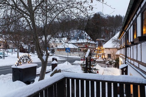 Twilight view of Hammerherrenhaus and village pyramid in snow, Frohnauer Hammer, Annaberg-Buchholz,