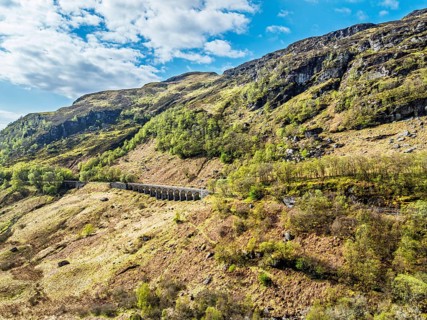 Mountains over Glen Ogle Viaduct from a drone, Road A85, Scotland, UK