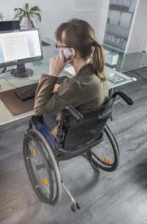 Young woman in a wheelchair at her workplace, Berlin, 18/01/2017