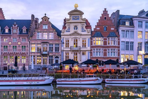Gastronomy and historic houses on the Korenlei quay on the river Leie at dusk, Ghent, Belgium