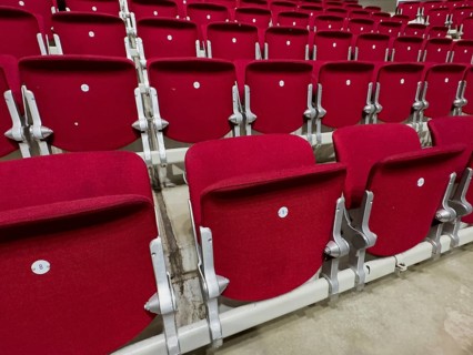 Empty folded-up seats Folding chairs with backrests in rows of seats mounted next to each other