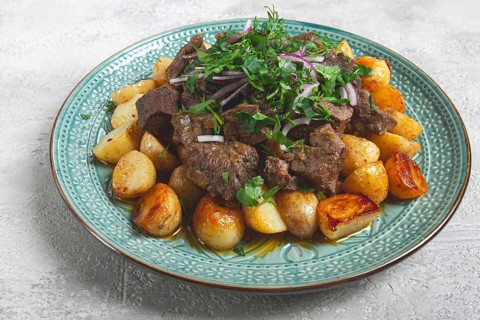 Kuyrdak, roast offal with potatoes and fresh herbs, homemade in Kazakh, no people
