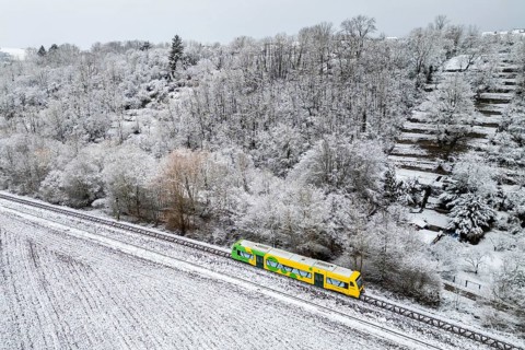 Aerial view of a regional railway on the Strohgäubahn of the type Regio-Shuttle RS 1 in Münchingen,
