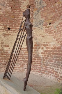 Metal sculpture, modern art, standing slender female figure with rods, torso, Limburg monastery