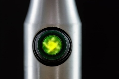 Green illuminated light switch on a lamp