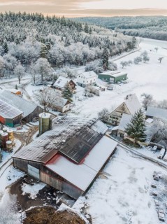 Detailed close-up of snow-covered buildings in a rural setting, Haselstaller Hof, Calw district,