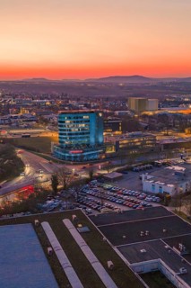A high-rise building in the city at sunset with a pink sky, Porsche, Bietigheim, Germany