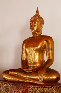 Sitting Buddha Gold Statue close up in Buddhist Temple. Wat Pho, Bangkok, Thailand