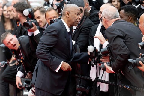Cannes, France - 19.5.2024: Denzel Washington talks to photographers during the - Highest 2 Lowest