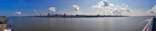 Panorama of a city by the river with blue sky and scattered clouds, Liverpool