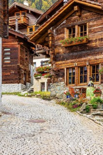 Old wooden houses decorated with flowers in the historic village centre, Grimentz, Val d'Anniviers,