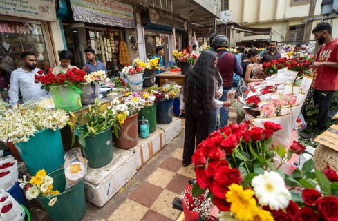 Customers browse red roses and other flowers at a roadside flower shop on Valentine's Day, in
