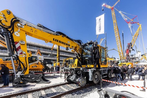Road-rail vehicle for track construction. LG 1800-1.0 lattice boom crane with a maximum lifting