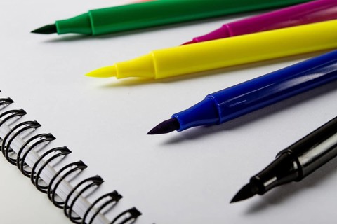 Watercolor pens brush, assortment, on a drawing album, artist's desk, top view, close-up, selective