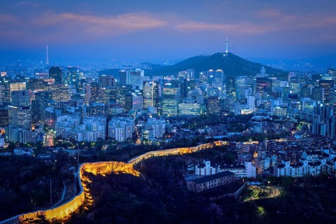 Seoul downtown cityscape illuminated with lights and Namsan Seoul Tower in the evening view from