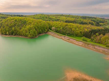 A lake surrounded by forest in a hilly landscape with a tranquil atmosphere, Glems reservoir,
