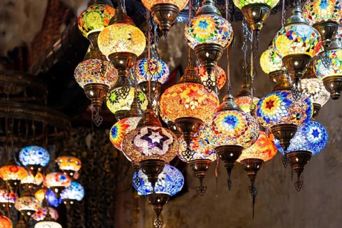 Vibrant handmade lamps hanging in a market in Jerusalem, near historical religious landmarks in the