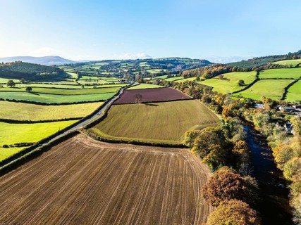 Fields and Farms over River Usk from a drone, Brecon, Brecon Beacons, Powys, Wales, England, United