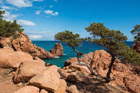 Hiking trail along the coast with red rocks and sea, Spiaggia di Coccorocci, near Tertenia,