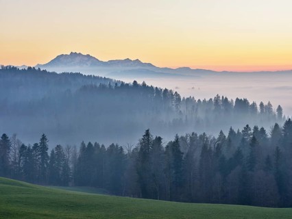 Foggy atmosphere in the light of the setting sun with a view of Mount Pilatus, Canton Zug,