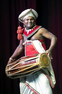 Sri Lankan musician with a traditional drum, Young Men's Buddhist Association, Kandy, Central