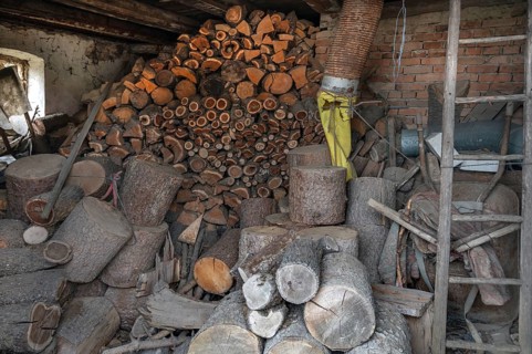 Stored firewood in an outbuilding on a farm, Bavaria, Germany