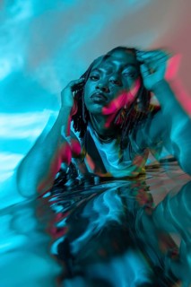 Futuristic portrait of an African young woman in the metaverse, enveloped in vivid colors and