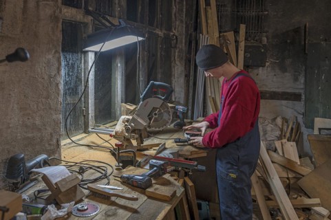 Young man at a Flex in his workshop, Mecklenburg-Vorpommern, Germany